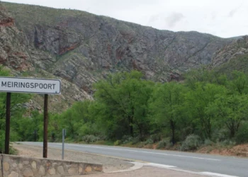 Floodwater and road clean-up equipment inside Meiringspoort after a flash flood shut the key N12 route in the Western Cape.