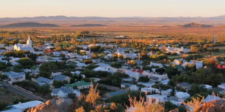 Wide view of the Middelpos village streetscape in the Upper Karoo, Northern Cape, showing historic low-rise Karoo architecture against a semi-desert landscape.
