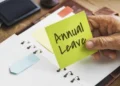 A South African office worker checking a leave calendar at a desk