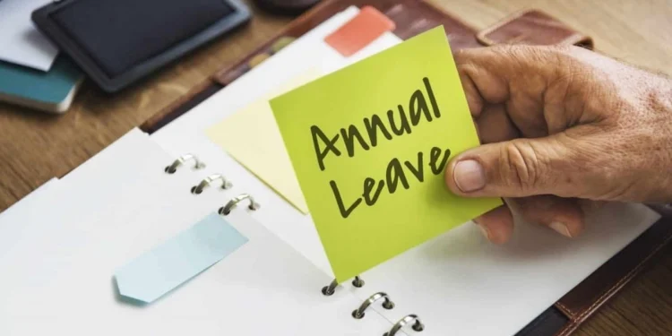 A South African office worker checking a leave calendar at a desk