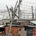 A tangle of unauthorised electrical cables strung between shacks in an informal settlement in South Africa