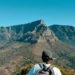A car stopped at the entrance gate of a South African national park with a game viewing road stretching ahead