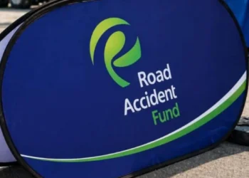 A damaged car at the roadside after a collision with emergency services attending the scene in South Africa