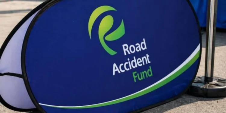 A damaged car at the roadside after a collision with emergency services attending the scene in South Africa
