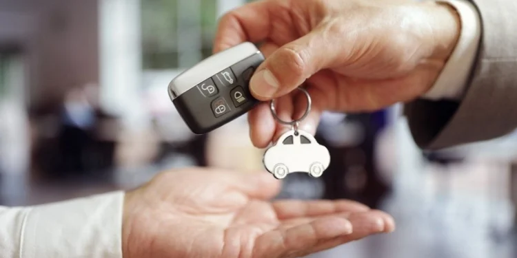 Buyer and seller completing vehicle transfer paperwork at a South African licensing office counter