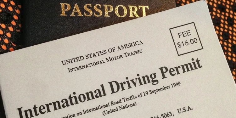 South African driving licence card and an international driving permit booklet on a table with a passport