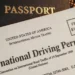 South African driving licence card and an international driving permit booklet on a table with a passport