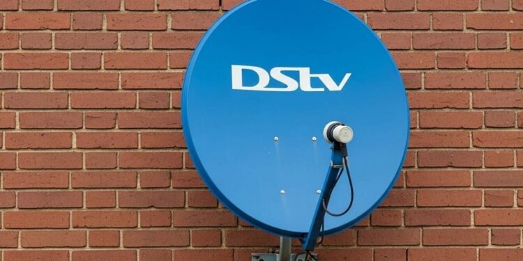A DStv decoder and remote on a television stand in a South African living room