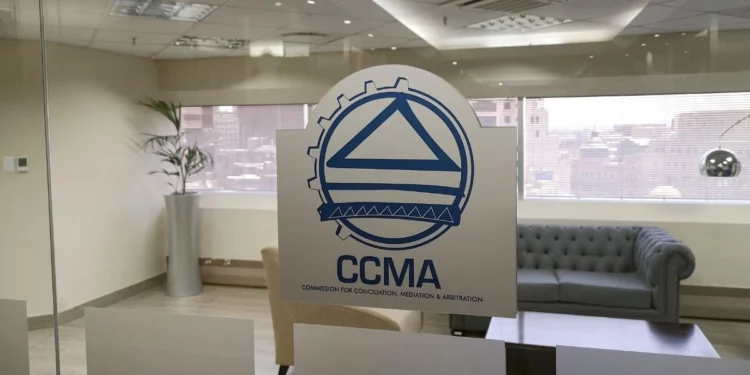 A worker filling in a CCMA referral form at a labour office counter