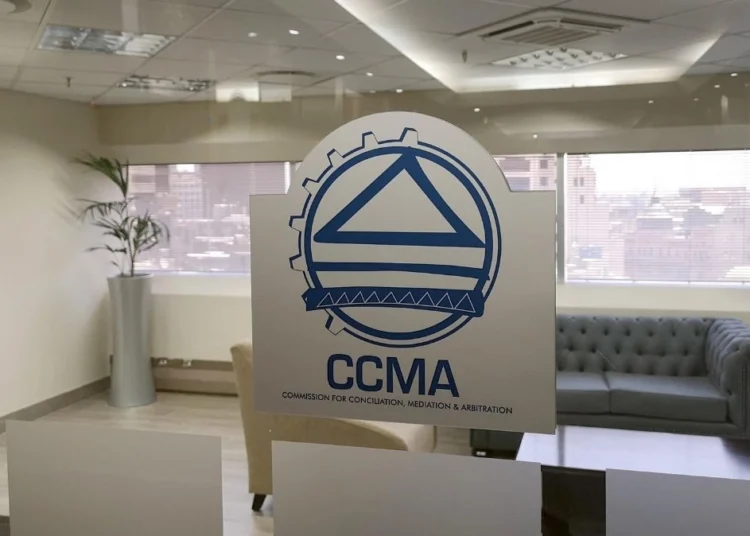 A worker filling in a CCMA referral form at a labour office counter