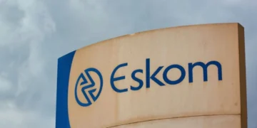 Eskom transformer and power lines above houses in a Gauteng township at dusk
