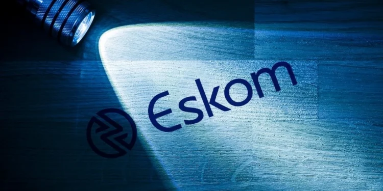 Eskom technicians working on a pole-mounted transformer above a township street