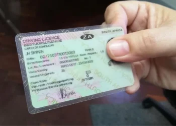 A South African citizen holding a temporary identity certificate at a Home Affairs office counter
