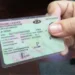 A South African citizen holding a temporary identity certificate at a Home Affairs office counter