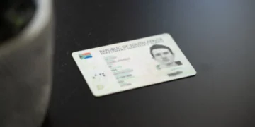 Customer having fingerprints scanned at a bank branch service counter