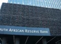 A shopper paying with a phone at a card machine in South Africa as non-bank payments get a 2027 start date